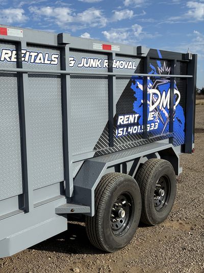 DMD Junk Removal 14-foot dump trailer, driveway-friendly rubber tires